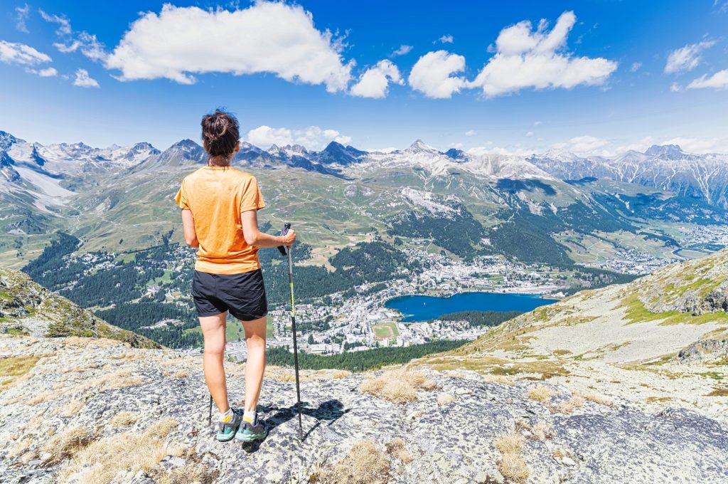 A woman observes the village of Sankt Moritz in Switzerland.