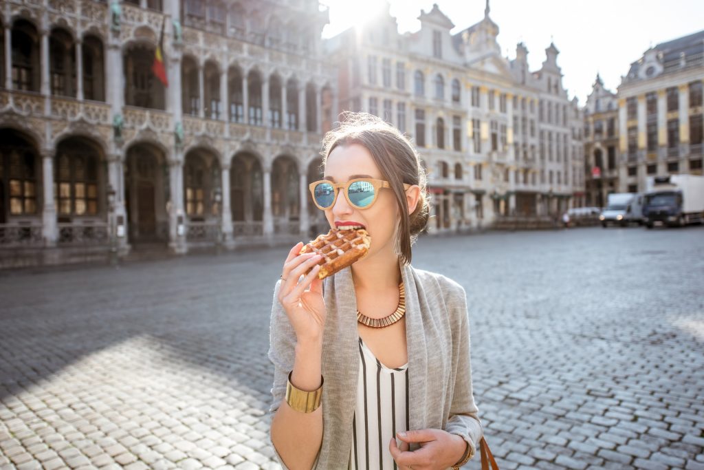 Woman with belgian waffle outdoors