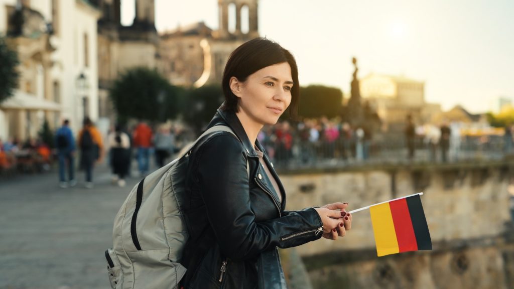 Young Woman Holds German Flag In Hand